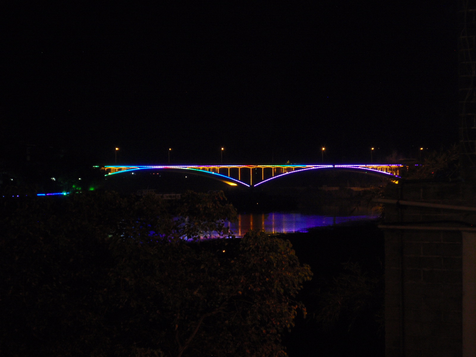 Yangshou bridge has colored night lights.